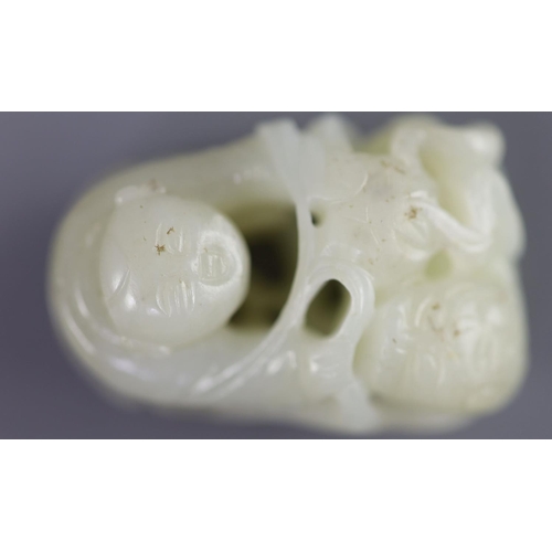 143 - A Chinese pale celadon jade group of a boy and a lion-dog, 19th/20th century,the lion-dog grasping r... 