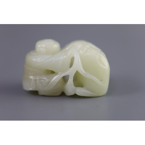 143 - A Chinese pale celadon jade group of a boy and a lion-dog, 19th/20th century,the lion-dog grasping r... 