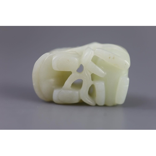 143 - A Chinese pale celadon jade group of a boy and a lion-dog, 19th/20th century,the lion-dog grasping r... 