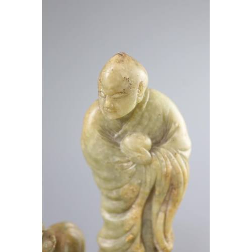 144 - A Chinese soapstone group of a luohan and a lion dog, possibly 17th/18th century,the figure holding ... 