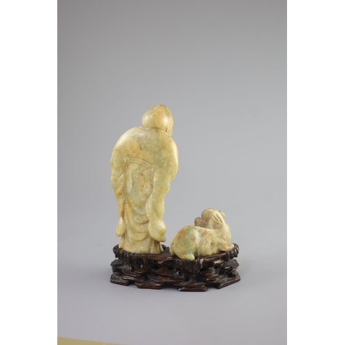 144 - A Chinese soapstone group of a luohan and a lion dog, possibly 17th/18th century,the figure holding ... 