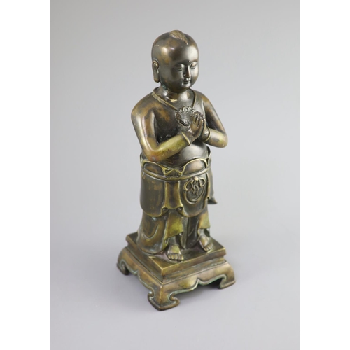 145 - A Chinese bronze standing figure of Shancai Tongzi,on a rectangular base with four shaped feet,34cm ... 