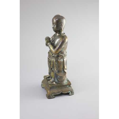 145 - A Chinese bronze standing figure of Shancai Tongzi,on a rectangular base with four shaped feet,34cm ... 