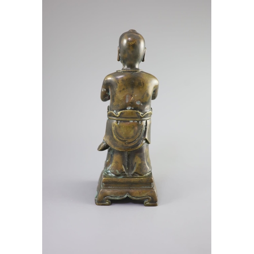 145 - A Chinese bronze standing figure of Shancai Tongzi,on a rectangular base with four shaped feet,34cm ... 