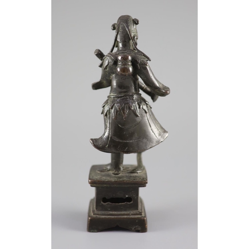 159 - A Chinese bronze figure of an immortal, late Ming dynasty,holding objects in each hand his right foo... 