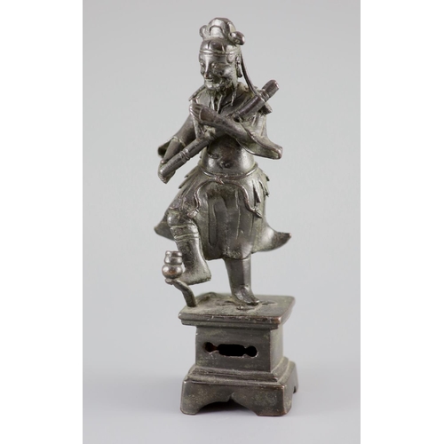 159 - A Chinese bronze figure of an immortal, late Ming dynasty,holding objects in each hand his right foo... 