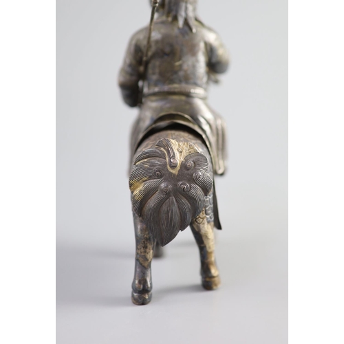 162 - A Chinese white metal model of a boy riding a qilin , early 20th century,well modelled with engraved... 