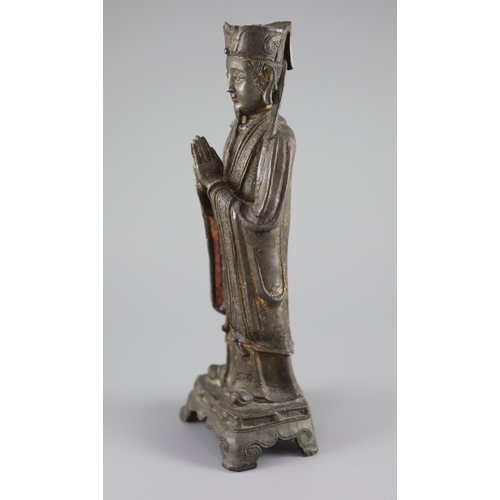 163 - A Chinese bronze standing figure of an immortal, late Ming, 17th century,with remnants of original p... 