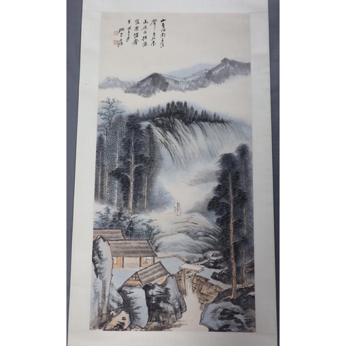 169 - A Chinese landscape scroll painting on paper, 20th century,depicting a scholar in a mountainous land... 