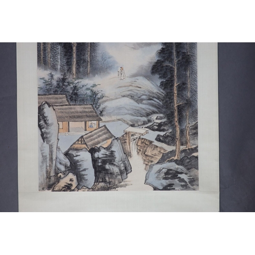 169 - A Chinese landscape scroll painting on paper, 20th century,depicting a scholar in a mountainous land... 