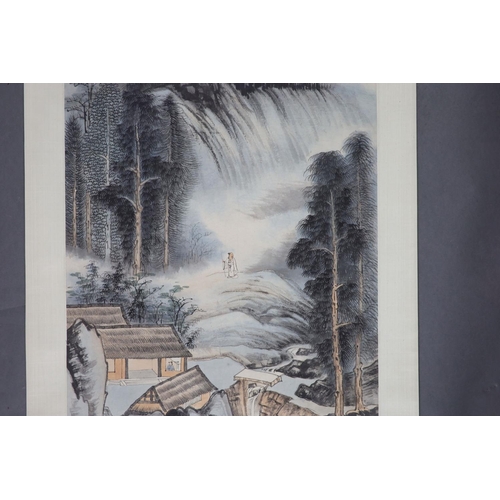 169 - A Chinese landscape scroll painting on paper, 20th century,depicting a scholar in a mountainous land... 