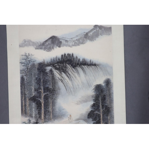 169 - A Chinese landscape scroll painting on paper, 20th century,depicting a scholar in a mountainous land... 