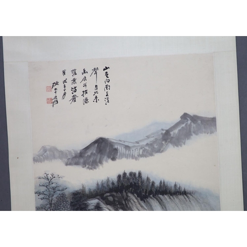 169 - A Chinese landscape scroll painting on paper, 20th century,depicting a scholar in a mountainous land... 