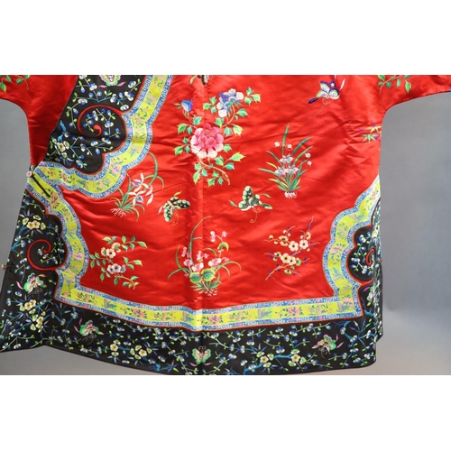 175 - A Chinese red silk robe, early 20th century,embroidered with spot motifs of butterflies, flowers and... 