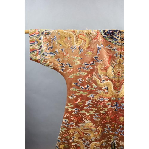 177 - A Chinese apricot embroidered silk dragon formal court robe, jifu, late Qing Dynasty,worked in sat... 