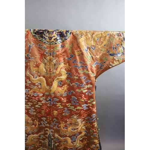 177 - A Chinese apricot embroidered silk dragon formal court robe, jifu, late Qing Dynasty,worked in sat... 