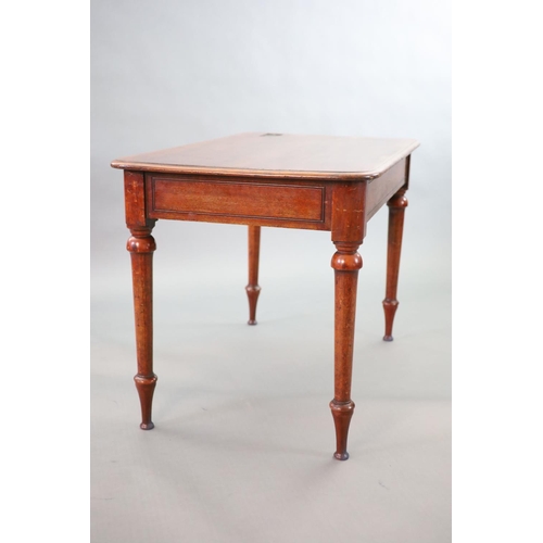 197 - A Victorian mahogany writing table,with rounded rectangular top, once fitted with an inkwell, on tur... 