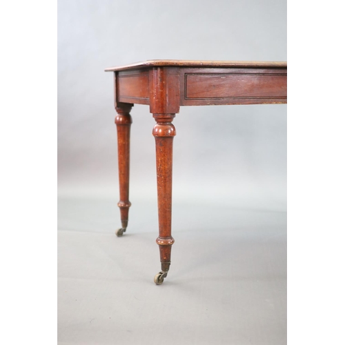 198 - A Victorian mahogany writing table,with rounded rectangular top, once inset with a brass topped inkw... 