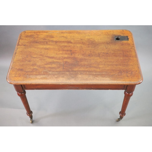 198 - A Victorian mahogany writing table,with rounded rectangular top, once inset with a brass topped inkw... 