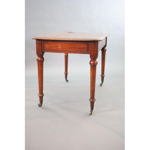 198 - A Victorian mahogany writing table,with rounded rectangular top, once inset with a brass topped inkw... 