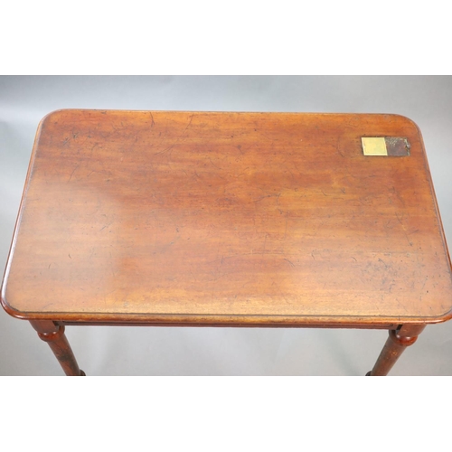 202 - A Victorian mahogany writing table,with rounded rectangular top inset with a brass capped inkwell, o... 