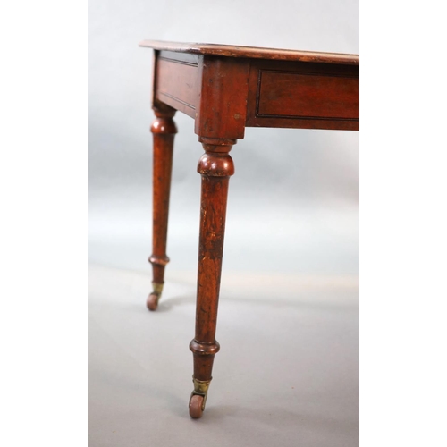 202 - A Victorian mahogany writing table,with rounded rectangular top inset with a brass capped inkwell, o... 