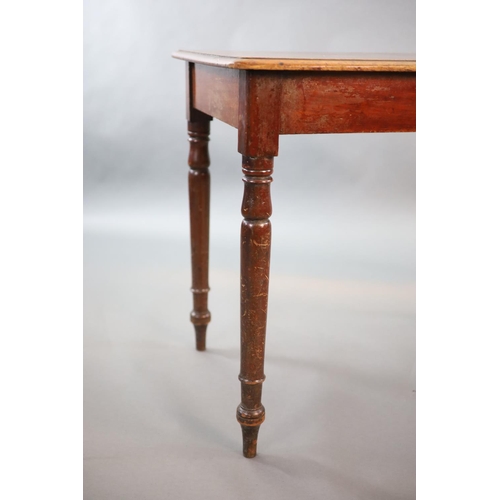 203 - A Victorian mahogany writing table,with rounded rectangular top and brass inset inkwell, on turned t... 