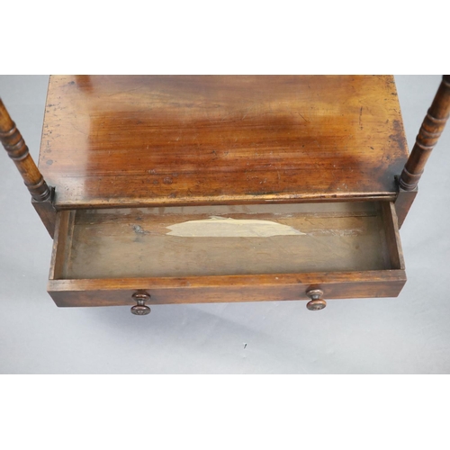 204 - An early Victorian rosewood whatnot,with three stages and base drawer, on ring turned tapered legs a... 