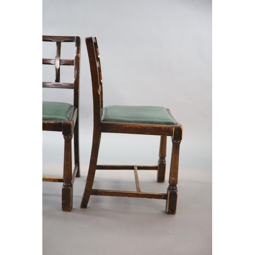 211 - A set of ten early 20th century oak and beech dining chairs,with cross frame backs and drop in seats... 