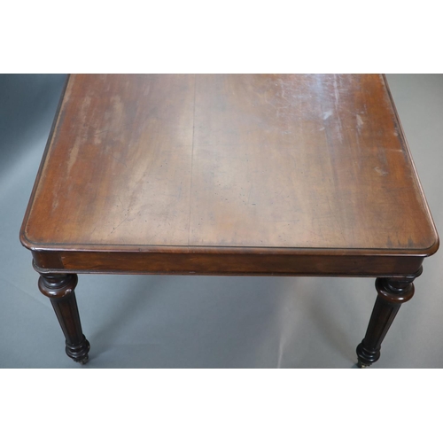 212 - A Victorian mahogany library table,with rounded rectangular top, on turned and fluted tapered legs, ... 