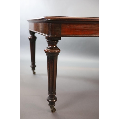 212 - A Victorian mahogany library table,with rounded rectangular top, on turned and fluted tapered legs, ... 