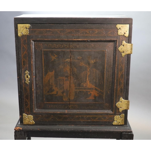 232 - An early 18th century European japanned cabinet on stand,the single panelled door with gilt brass mo... 