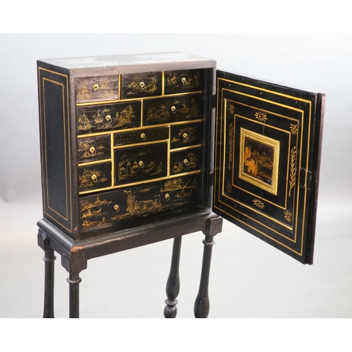 232 - An early 18th century European japanned cabinet on stand,the single panelled door with gilt brass mo... 