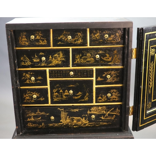 232 - An early 18th century European japanned cabinet on stand,the single panelled door with gilt brass mo... 