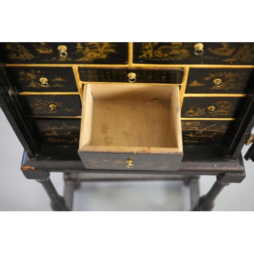 232 - An early 18th century European japanned cabinet on stand,the single panelled door with gilt brass mo... 