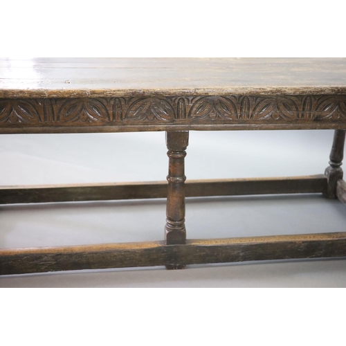 239 - A 17th century oak and elm refectory table,with rectangular top, foliate carved frieze and cannon ba... 