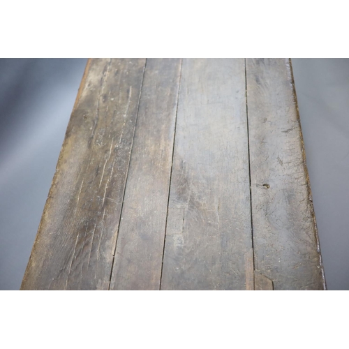 239 - A 17th century oak and elm refectory table,with rectangular top, foliate carved frieze and cannon ba... 