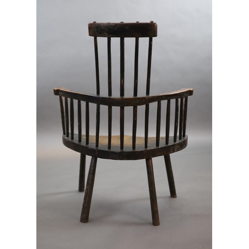 240 - An 18th century primitive vernacular comb-back elbow chair, possibly Welsh,with remnants of original... 