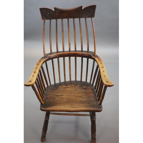 241 - A primitive comb back Windsor armchair, possibly West Country,with a shaped rail above a notch-cut b... 