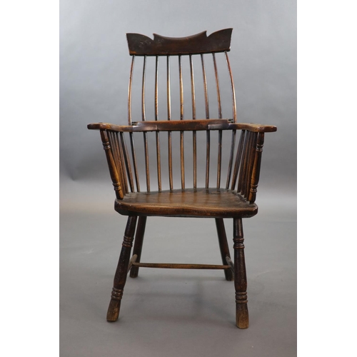 241 - A primitive comb back Windsor armchair, possibly West Country,with a shaped rail above a notch-cut b... 