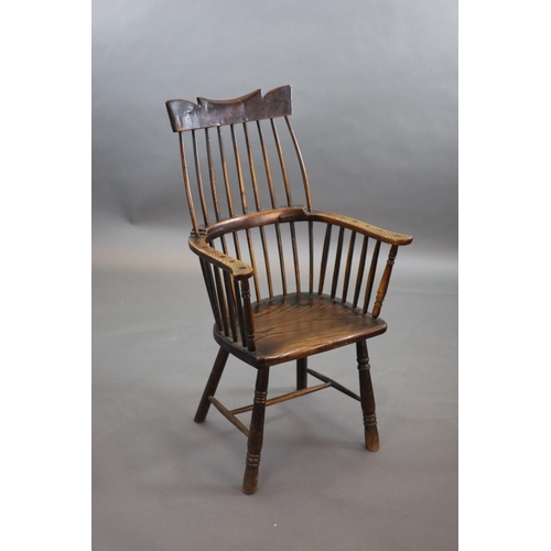 241 - A primitive comb back Windsor armchair, possibly West Country,with a shaped rail above a notch-cut b... 