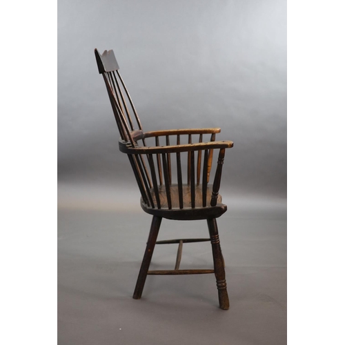 241 - A primitive comb back Windsor armchair, possibly West Country,with a shaped rail above a notch-cut b... 