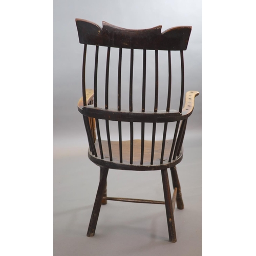 241 - A primitive comb back Windsor armchair, possibly West Country,with a shaped rail above a notch-cut b... 