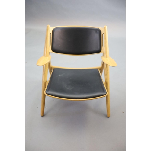 271 - Hans Wegner for Carl Hansen, an oak and oak laminate framed Sawback armchair,with black leather co... 