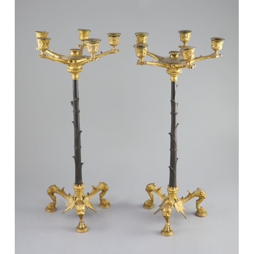 46 - A pair of Barbedienne style five branch ormolu candelabra, 19th century,each raised on three puma ma... 