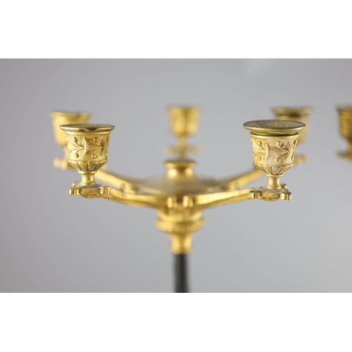 46 - A pair of Barbedienne style five branch ormolu candelabra, 19th century,each raised on three puma ma... 