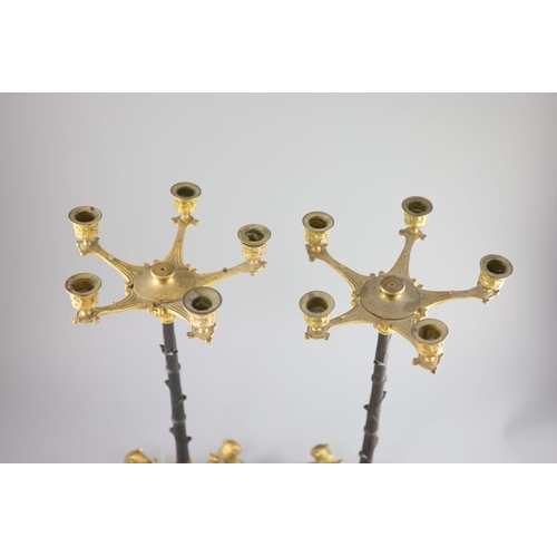 46 - A pair of Barbedienne style five branch ormolu candelabra, 19th century,each raised on three puma ma... 