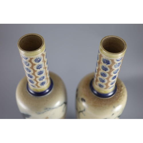 62 - A large pair of Martin Brothers 'eagle and vulture' stoneware vases, dated 1878,each decorated in s... 