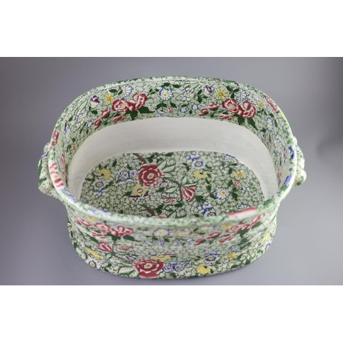 74 - A Victorian ironstone two handled footbath, c.1840,green printed and over enamelled with pink yellow... 