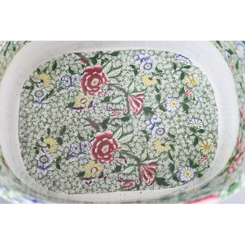 74 - A Victorian ironstone two handled footbath, c.1840,green printed and over enamelled with pink yellow... 